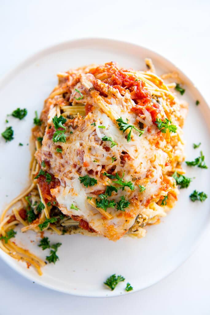 slow cooker spaghetti lasagna with melted cheese on a white plate