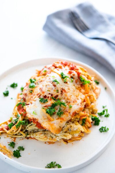 slow cooker spaghetti lasagna with melted cheese on a white plate