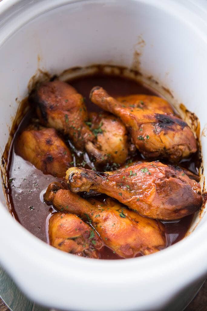 Slow Cooker Buffalo Chicken Drumsticks in white slow cooker 