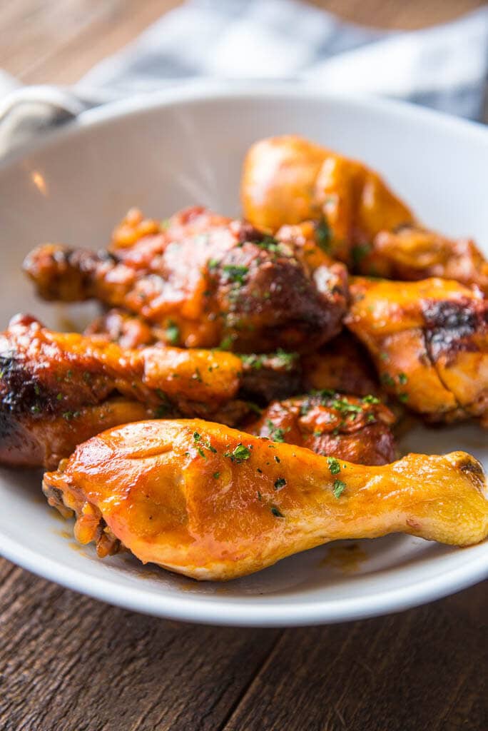 Closeup of Slow Cooker Buffalo Chicken Drumsticks in white bowl