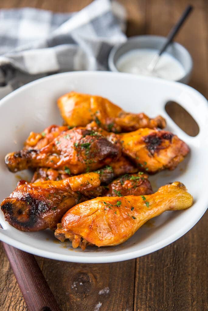 Slow Cooker Buffalo Chicken Drumsticks in white bowl