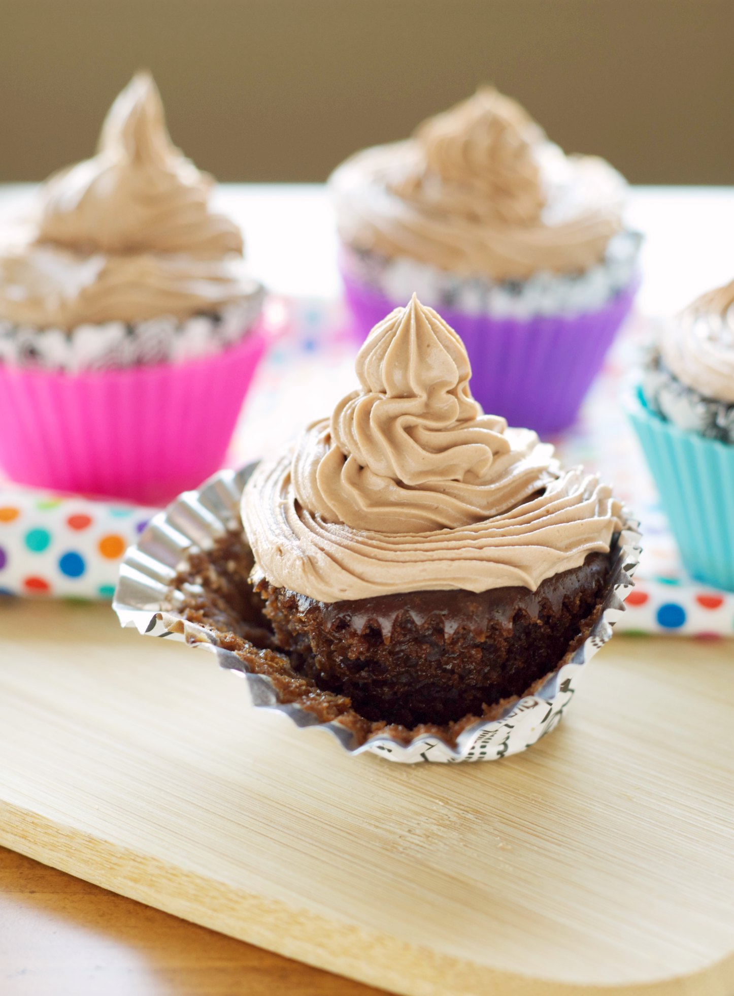 Hazelnut cupcake with several multicolored cupcakes in background