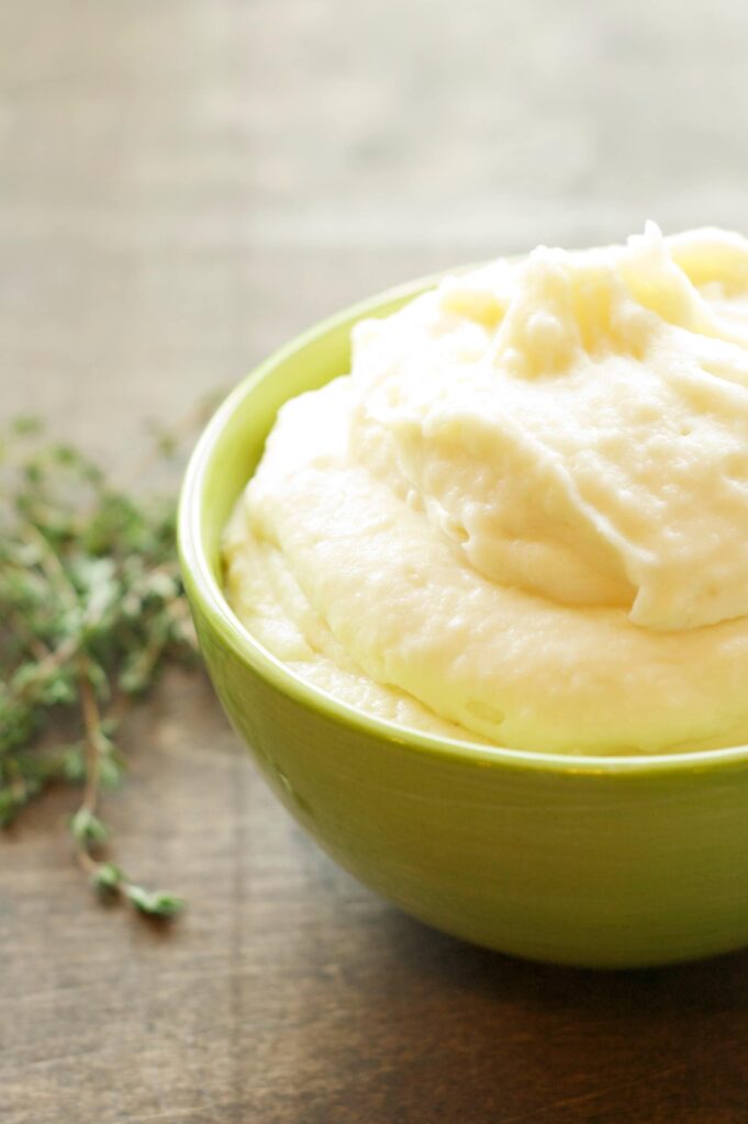 slow cooker garlic mashed potatoes in green bowl