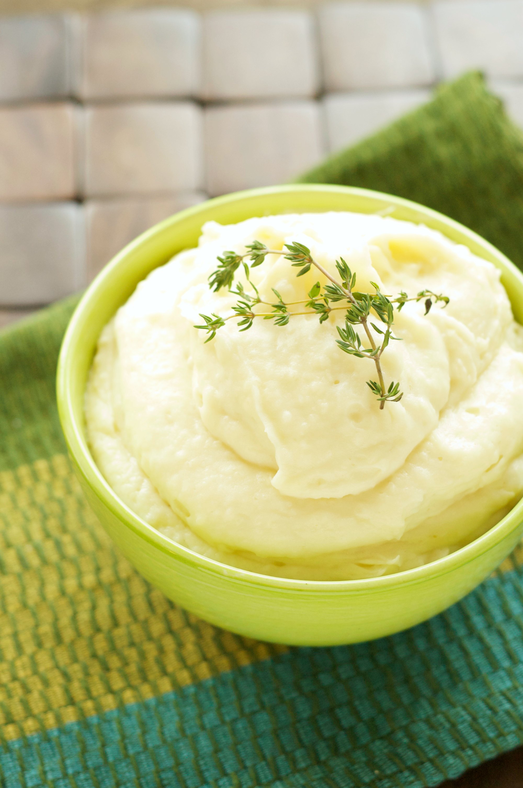 Mashed Potatoes in lime green bowl on green napkin