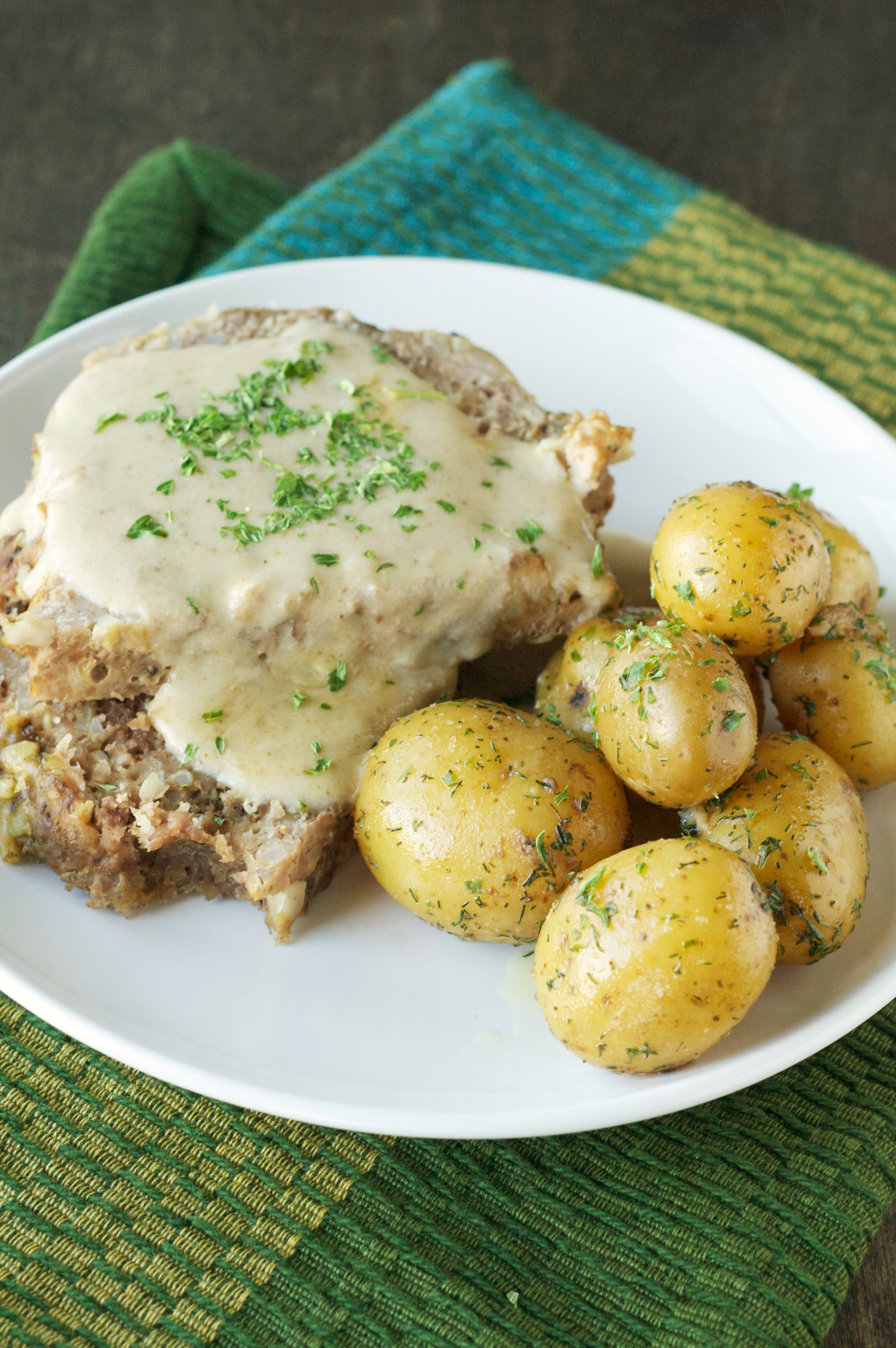 Slow Cooker Creamy Meatloaf with Baby Dill Potatoes on white plate 