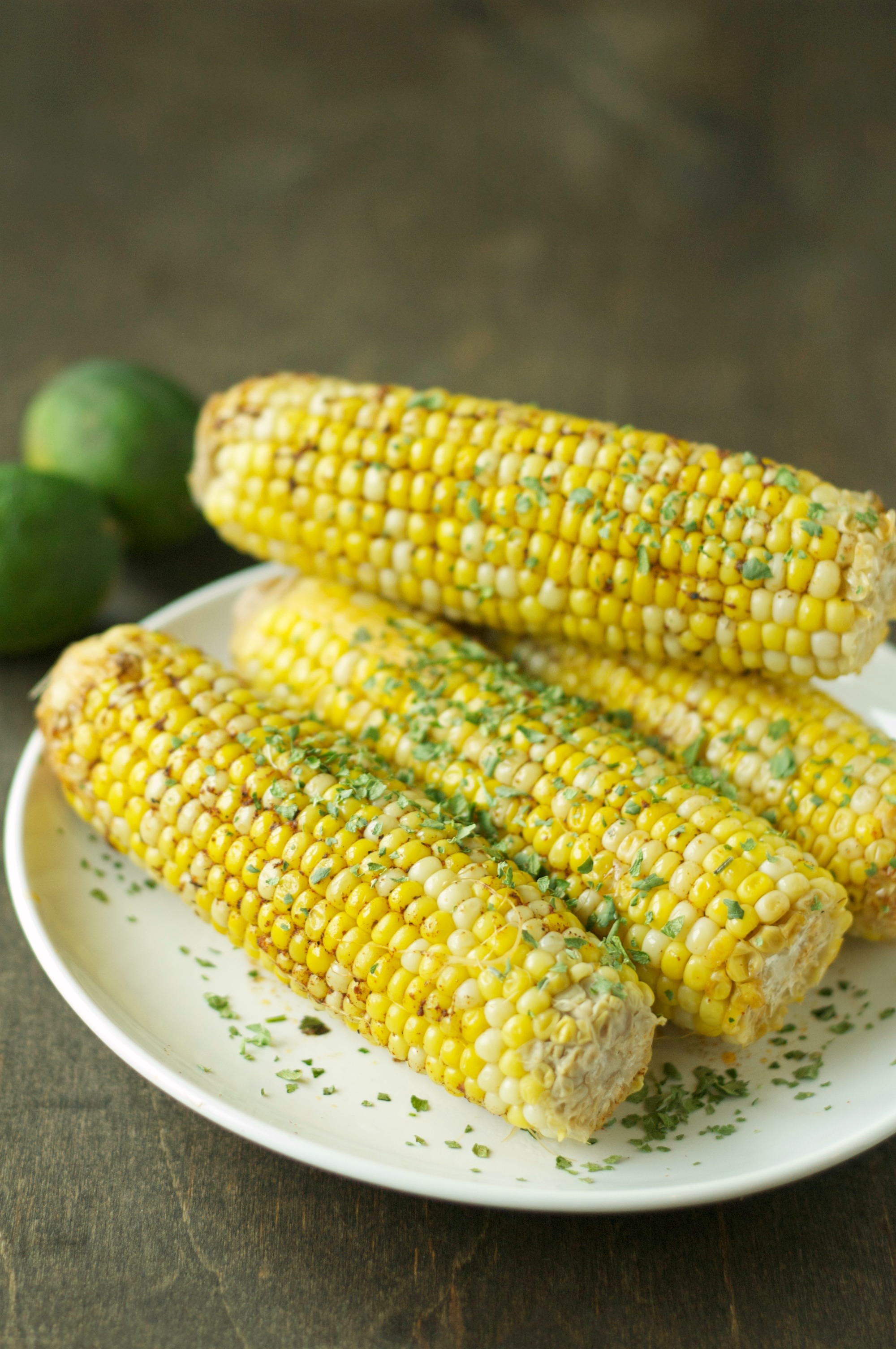 four pieces of corn on the cob on white plate