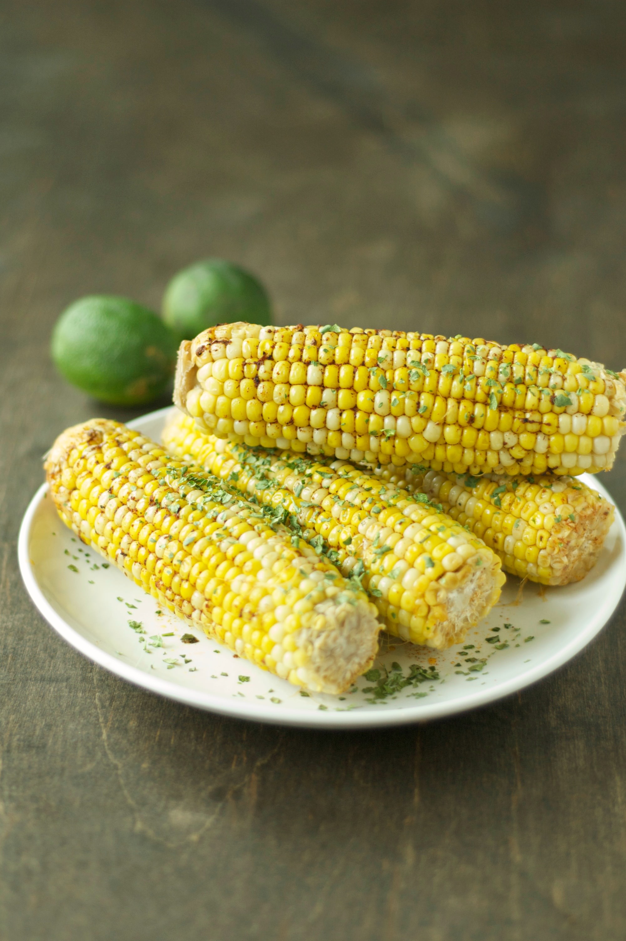 four pieces of corn on the cob on white plate