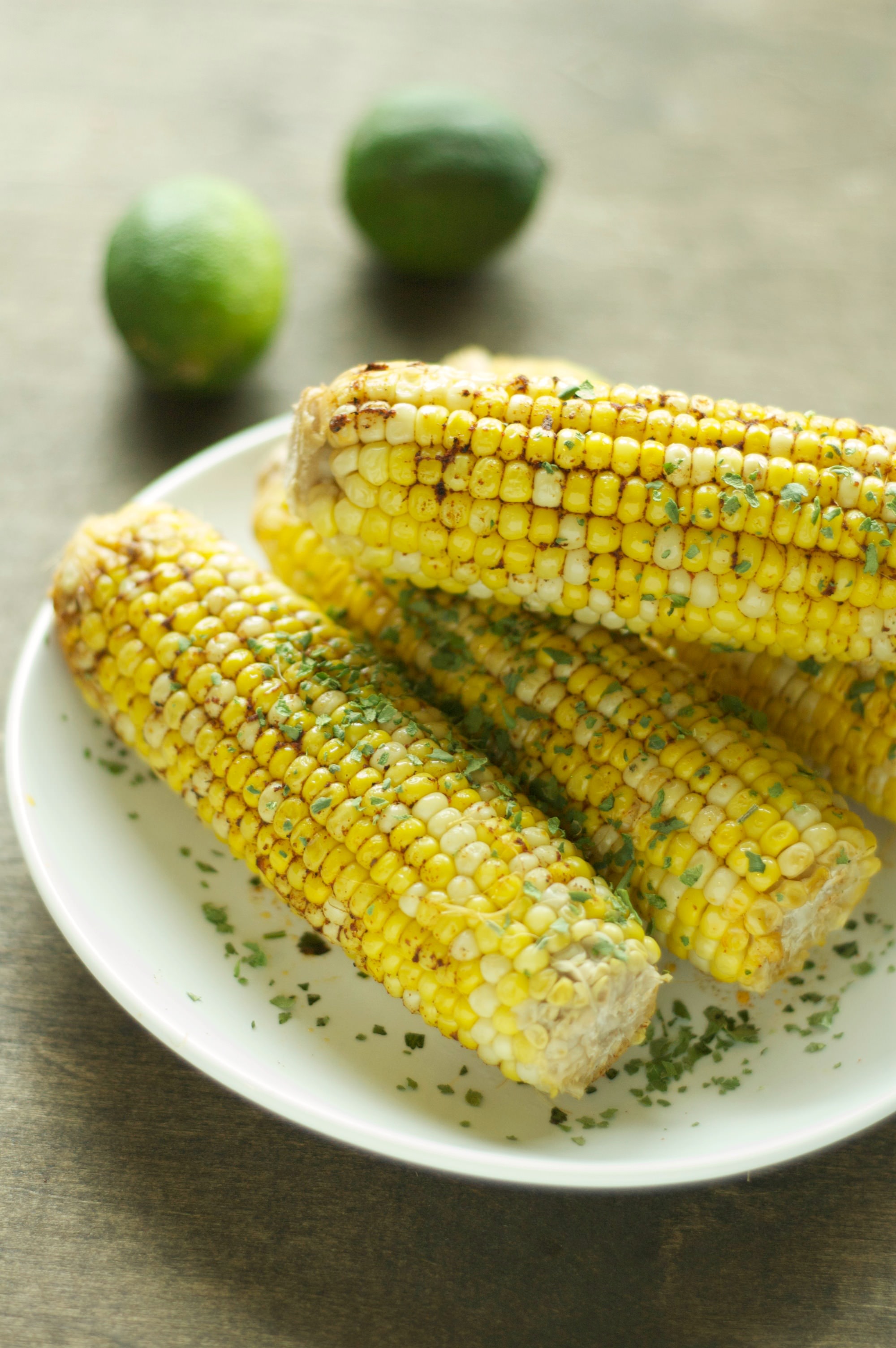 four pieces of corn on the cob on white plate