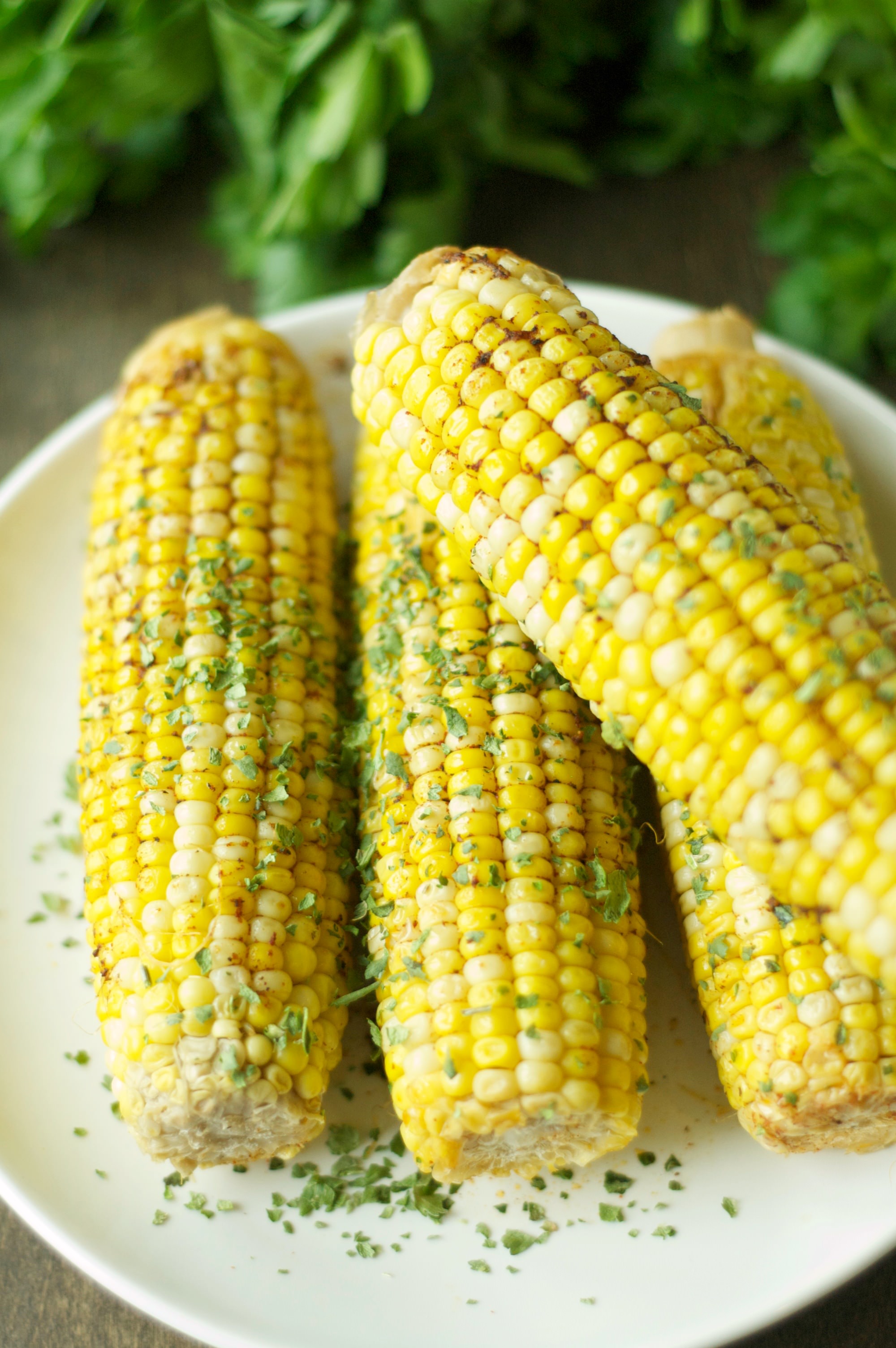 four pieces of corn on the cob on white plate