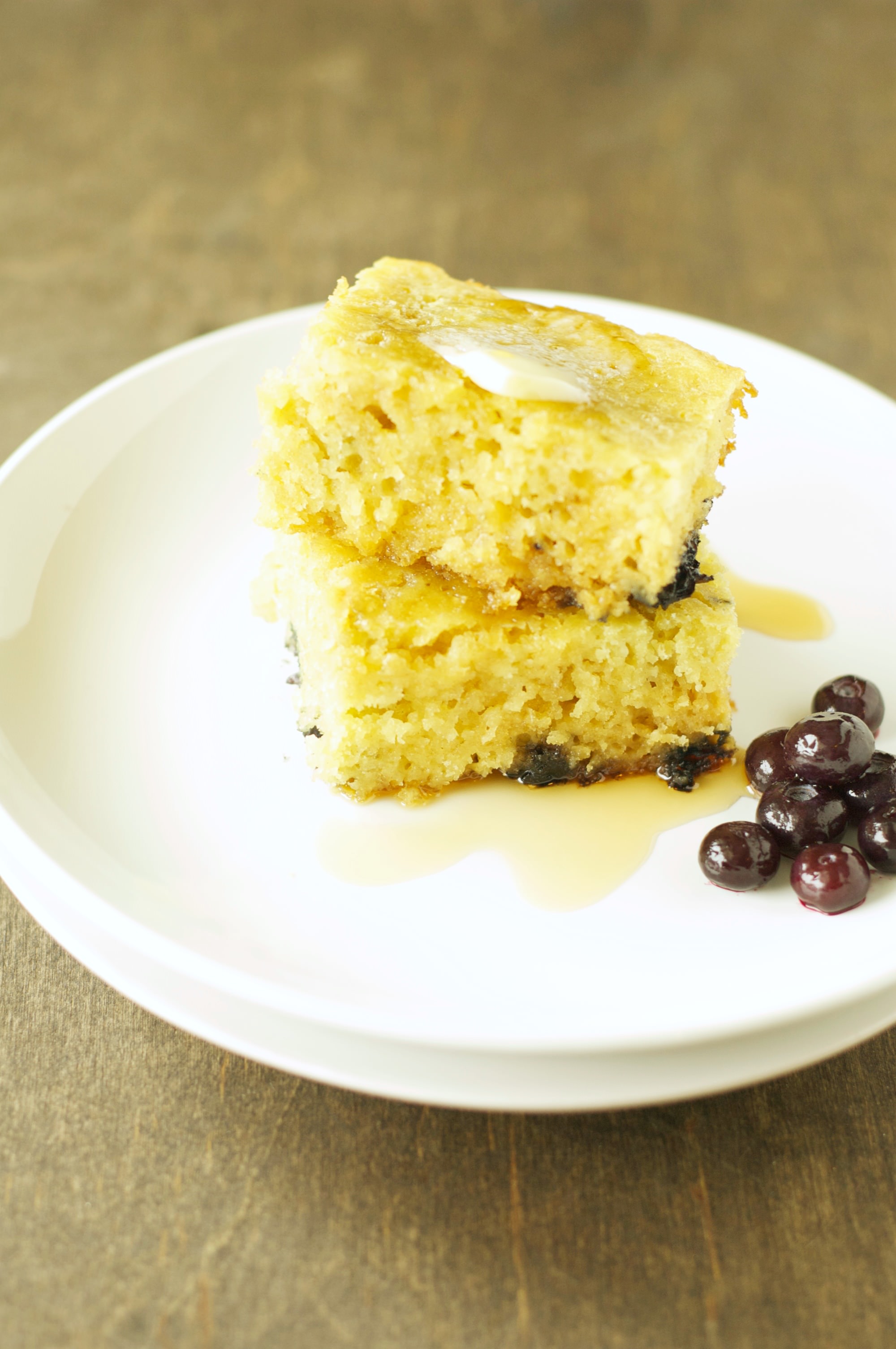 Two stacked Slow Cooker Blueberry Vanilla Pancakes on white plate