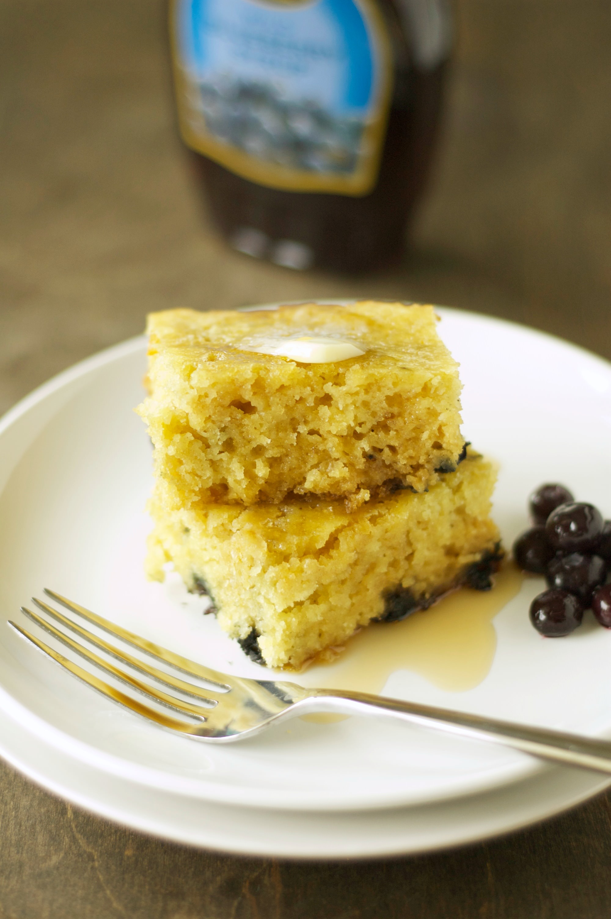 Two stacked Slow Cooker Blueberry Vanilla Pancakes on white plate