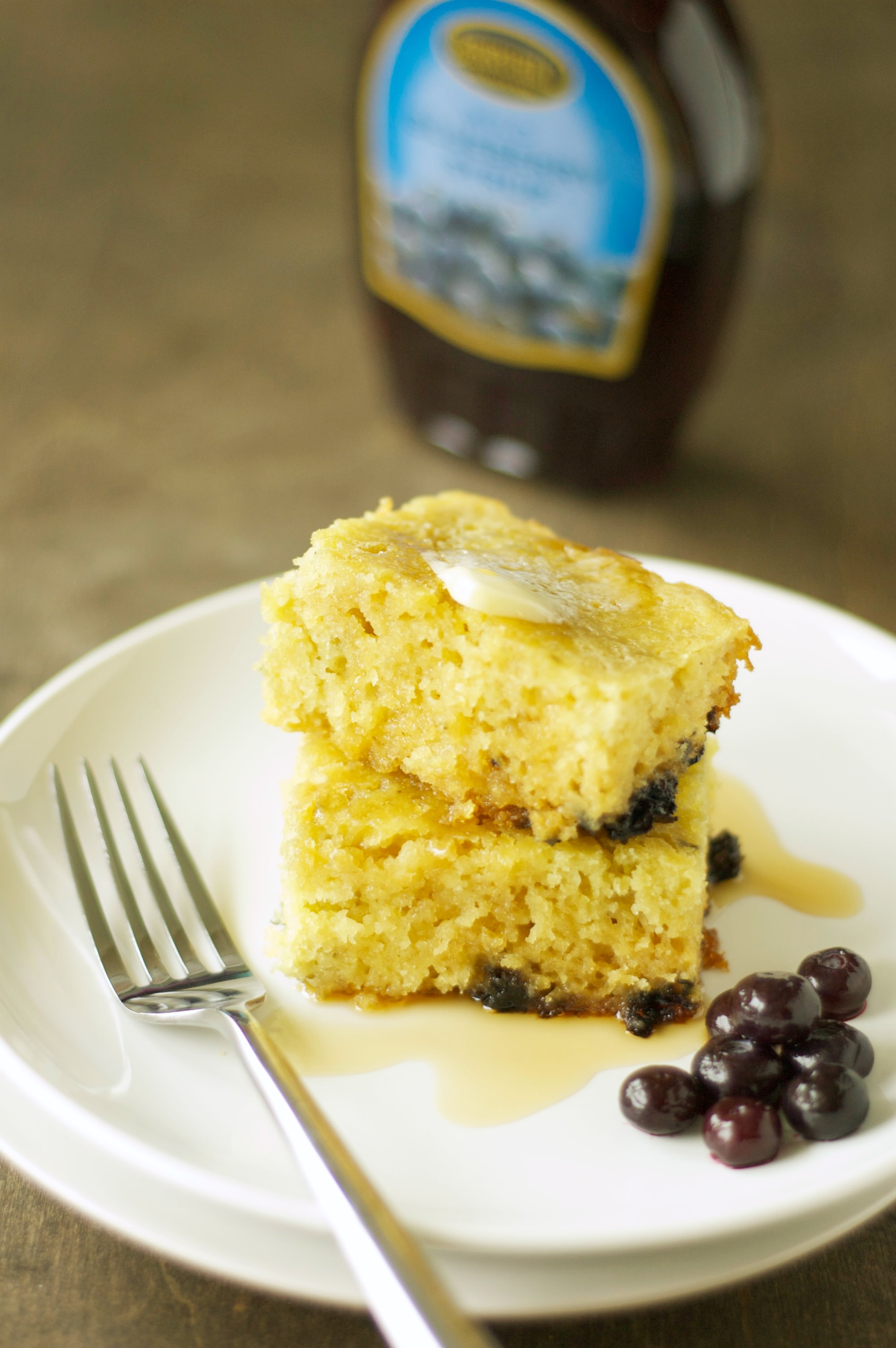 Two stacked Slow Cooker Blueberry Vanilla Pancakes on white plate