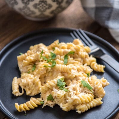 Slow Cooker Mac and Cheese is a simple and easy way to make totally homemade mac and cheese without a ton of work. Add garlic chicken to make it a filling meal the whole family will love.