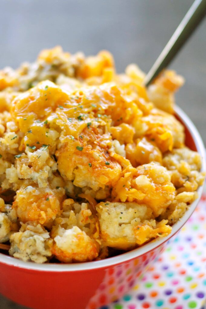 Slow Cooker Buffalo Chicken Tater Tot Casserole in red bowl