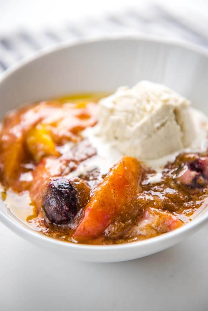 slow cooker peach and cherry cobbler in white bowl