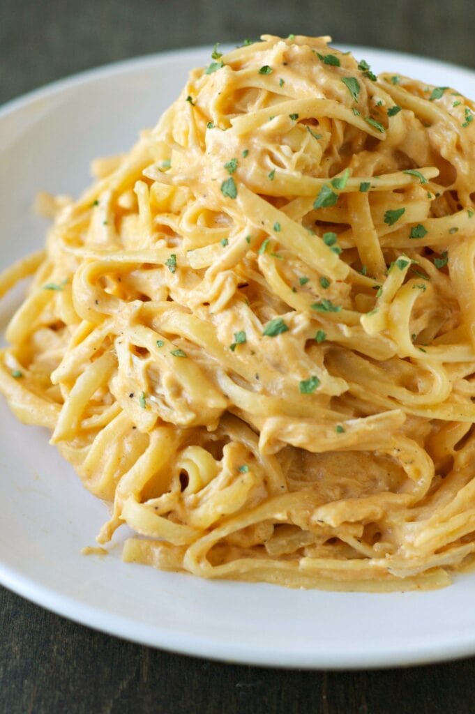 Slow Cooker Cheesy Buffalo Chicken Pasta piled high on a white plate