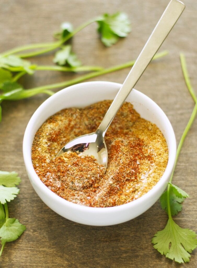 Homemade Seasoning Mix blended in small white bowl with spoon