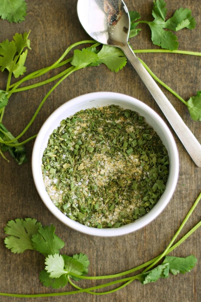 Homemade Seasoning Mix blended in white bowl with spoon on side 