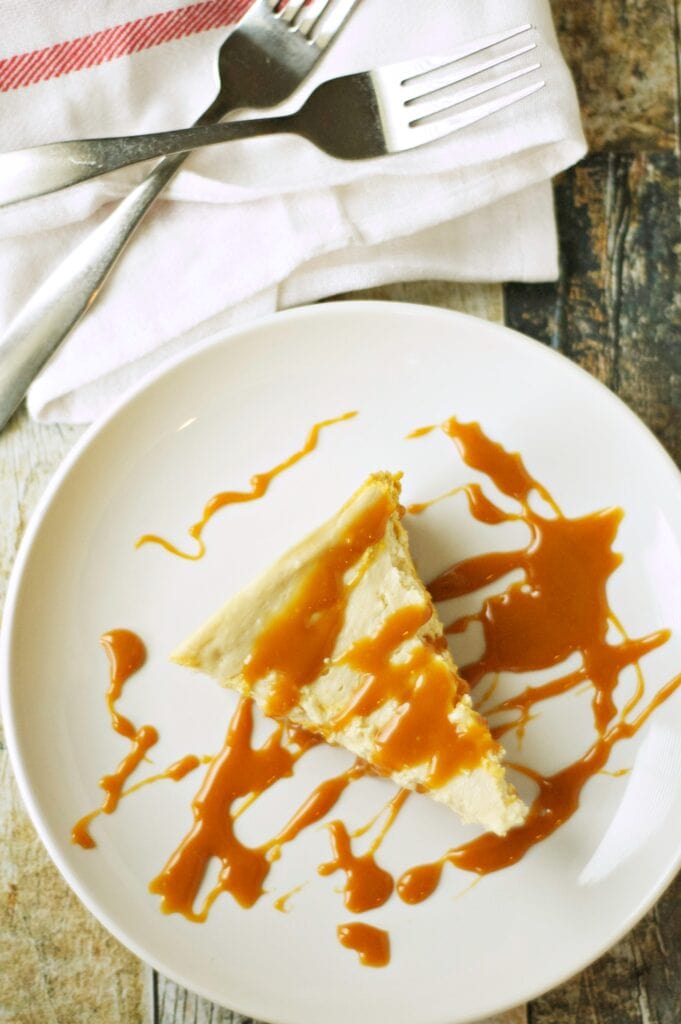 Slice of Slow Cooker Browned Butter Pumpkin Cheesecake with 2 forks