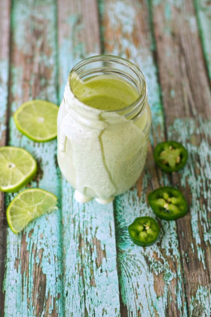 Zesty Lime Jalapeno Ranch in mason jar with lime and jalapeno slices