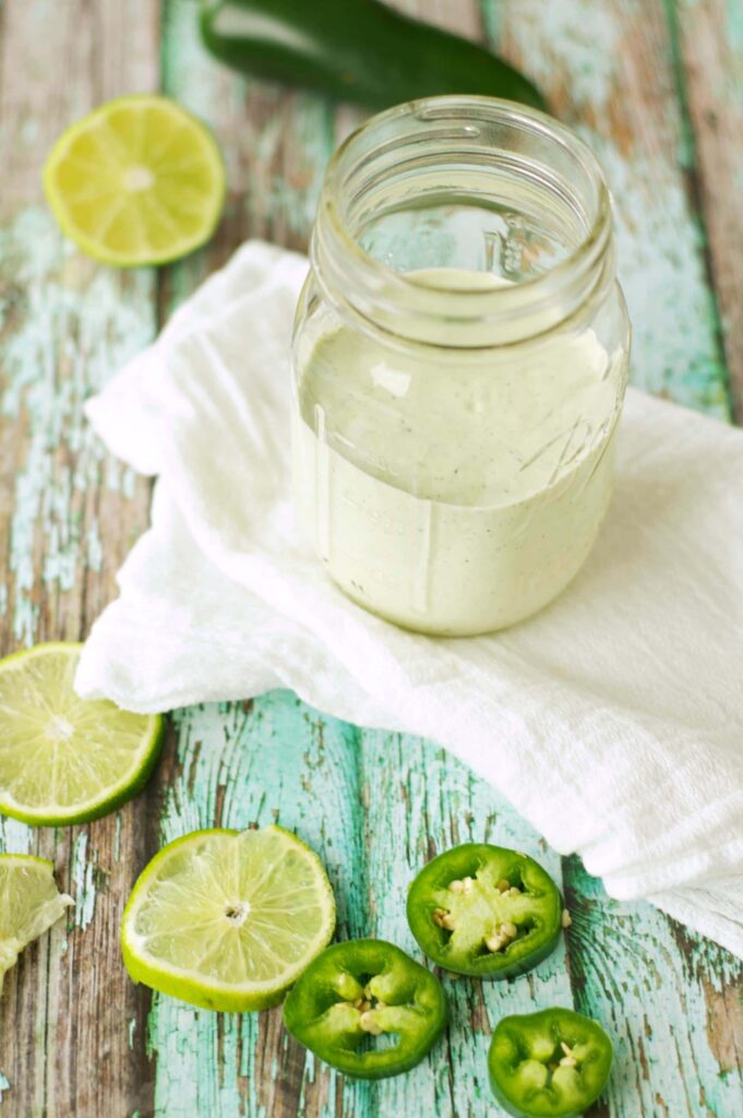 Zesty Lime Jalapeno Ranch in mason jar with lime and jalapeno slices