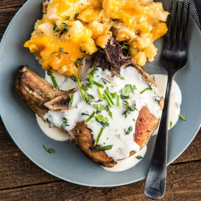 Slow Cooker Pork Chops are always a family favorite. This bone in version includes a Creamy Herb Sauce that takes it over the top in flavor!
