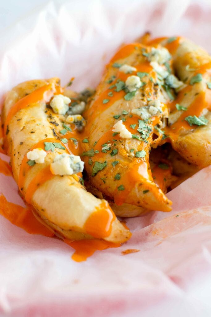 Slow Cooker Ranch Buffalo Chicken Tenders in basket with parchment paper