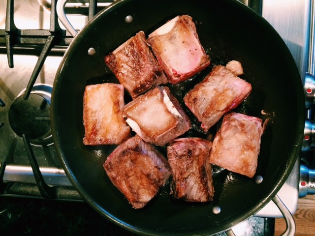 browning short ribs in skillet on stove
