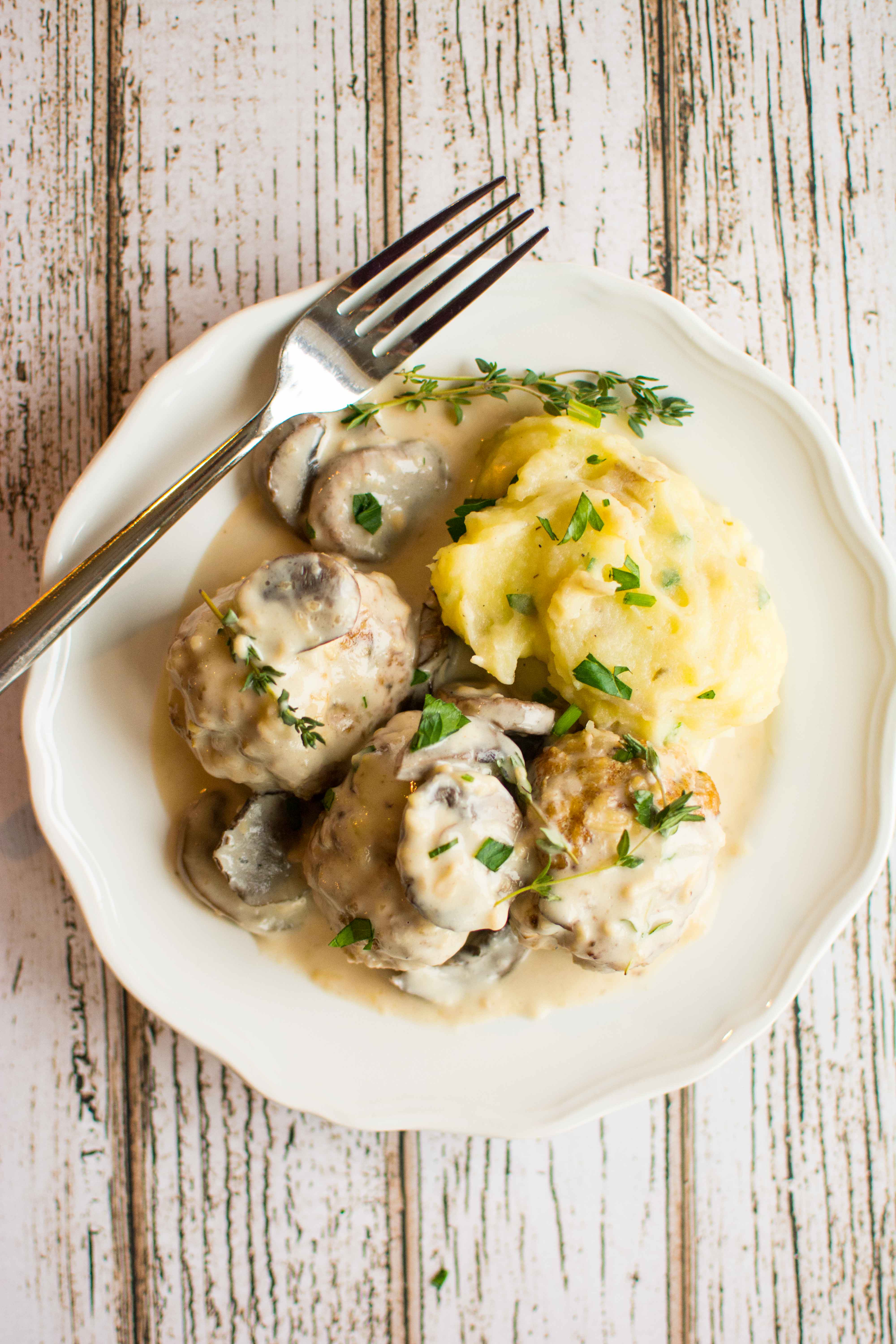 chicken meatballs and mashed potatoes on white plate with fork
