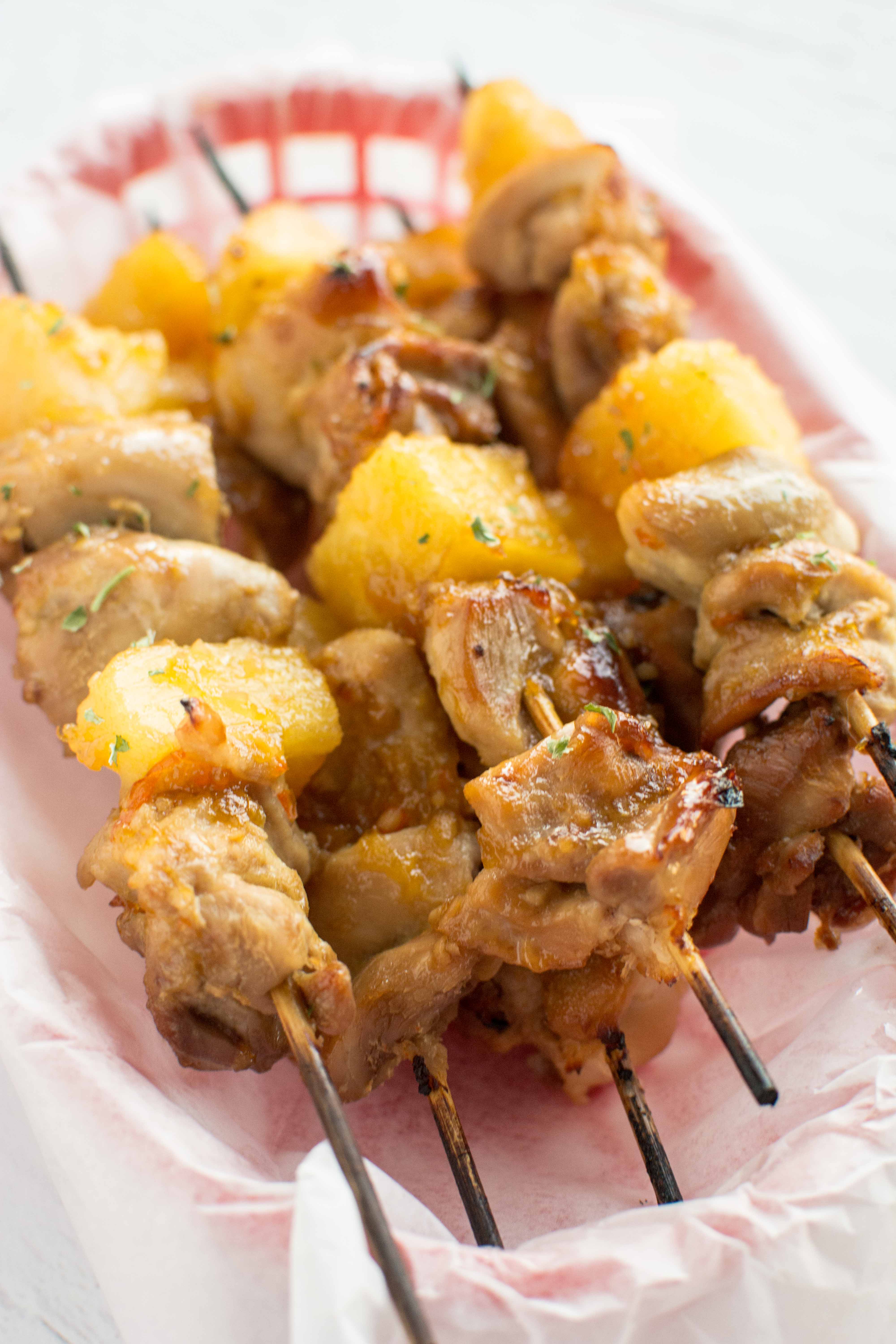 slow cooker chicken skewers in parchment paper lined red basket