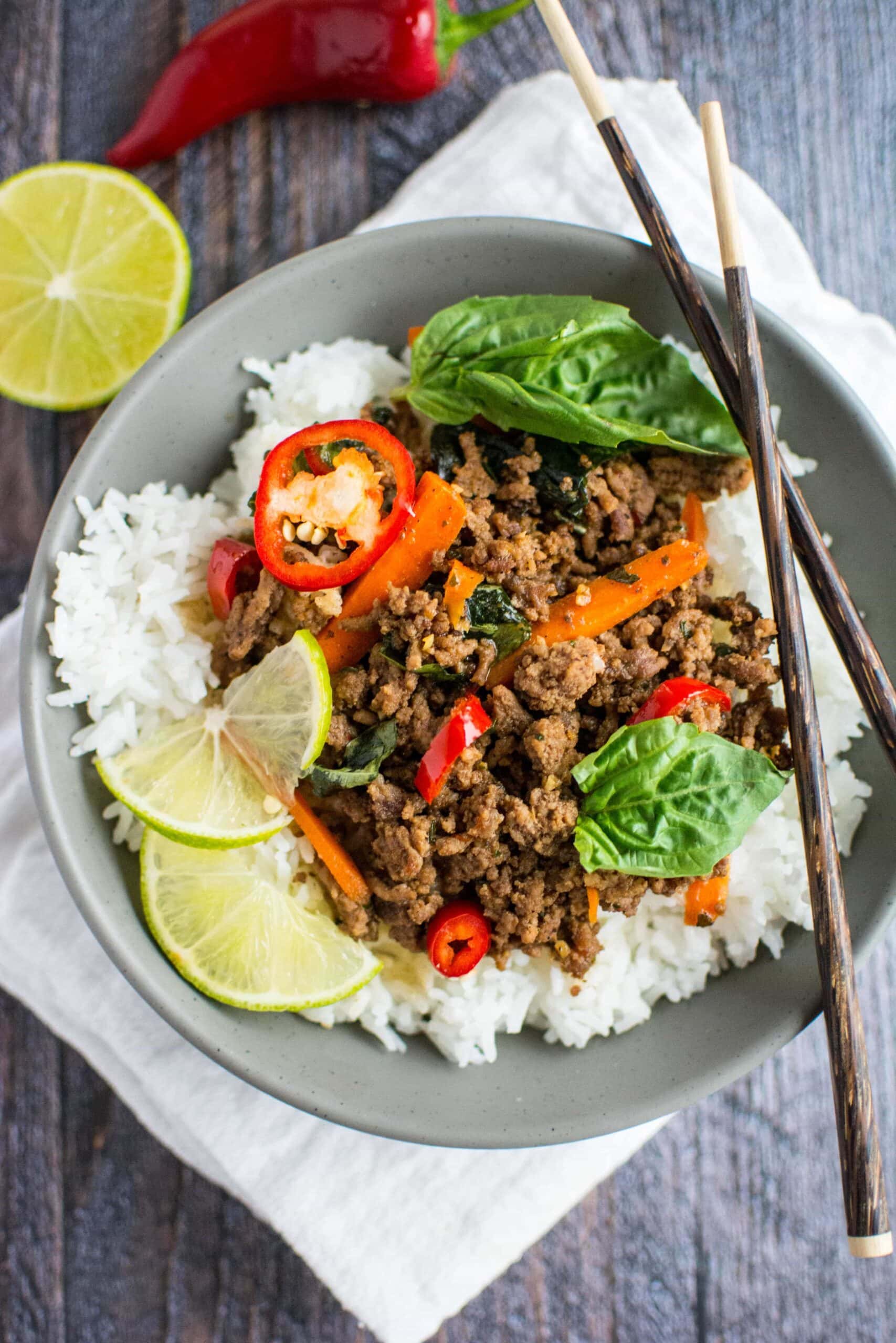 Thai Basil Beef in gray bowl with set of chopsticks