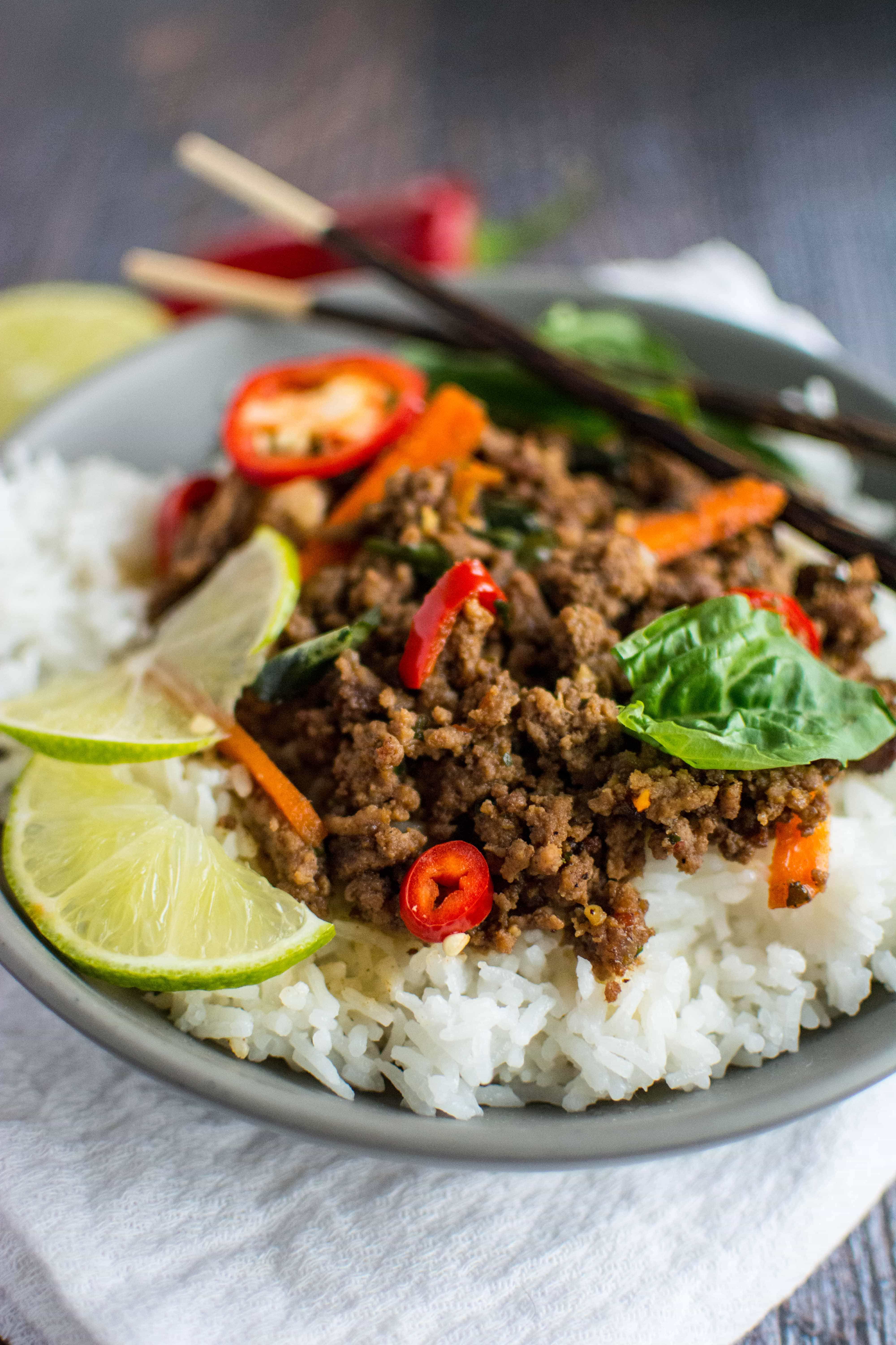 Thai Basil Beef in gray bowl with set of chopsticks
