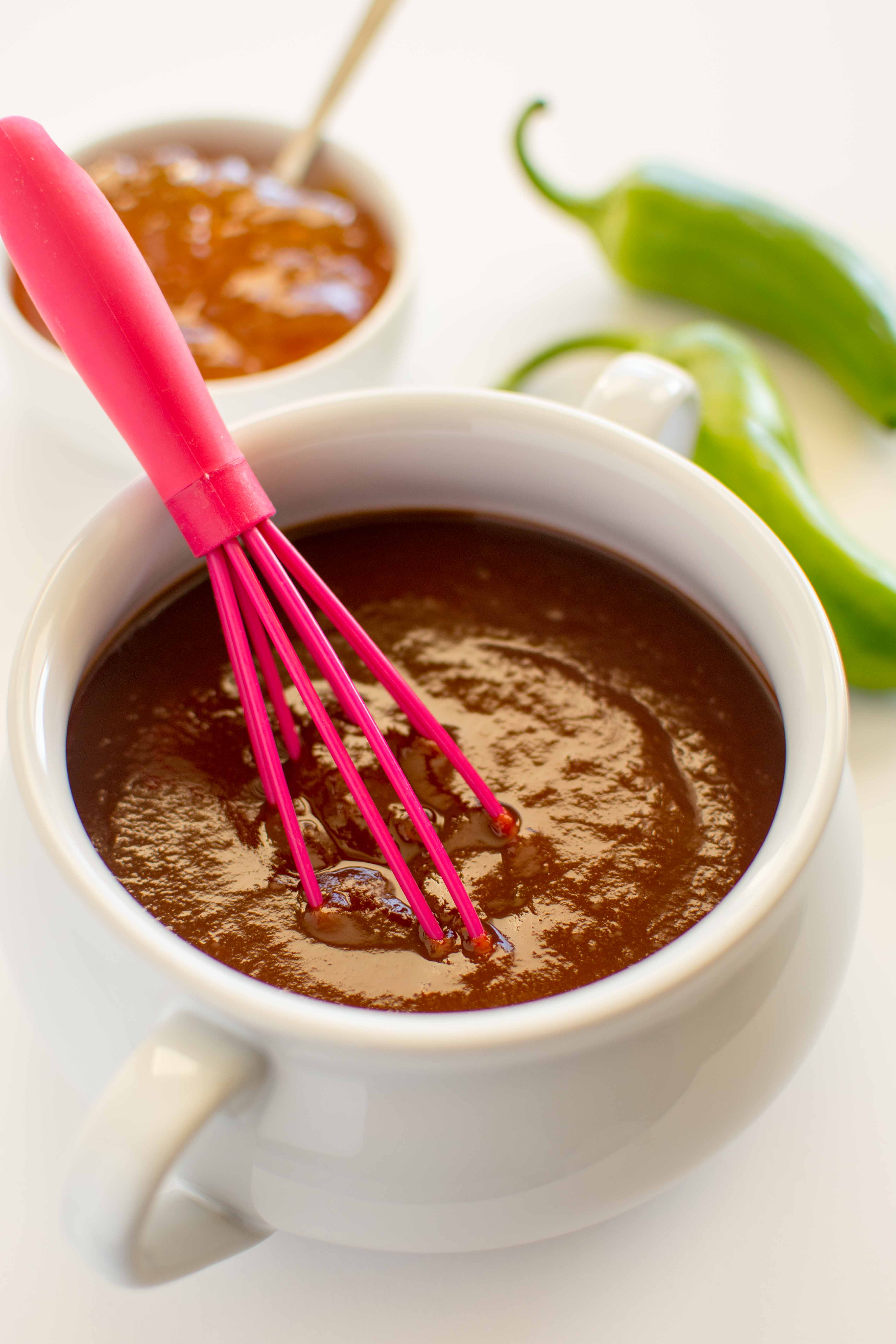 bbq sauce in white bowl with pink whisk