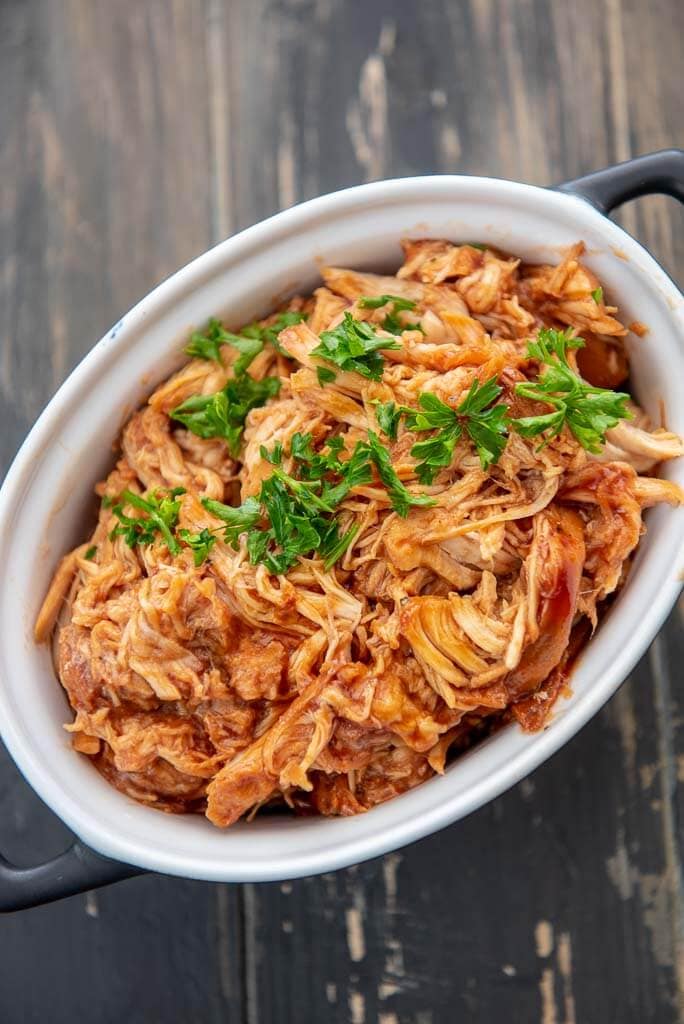 slow cooker bbq pulled chicken in a black and white ramekin