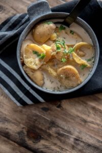 Slow Cooker Skinny Potato Soup in metal bowl with black napkin