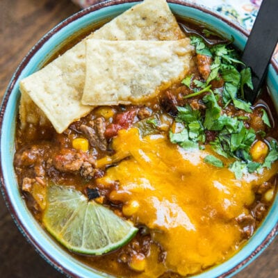 Slow Cooker Taco Soup is a family favorite dinner that has just a few ingredients and can be made in minutes. My secret ingredients makes it the best taco soup out there for flavor and richness!