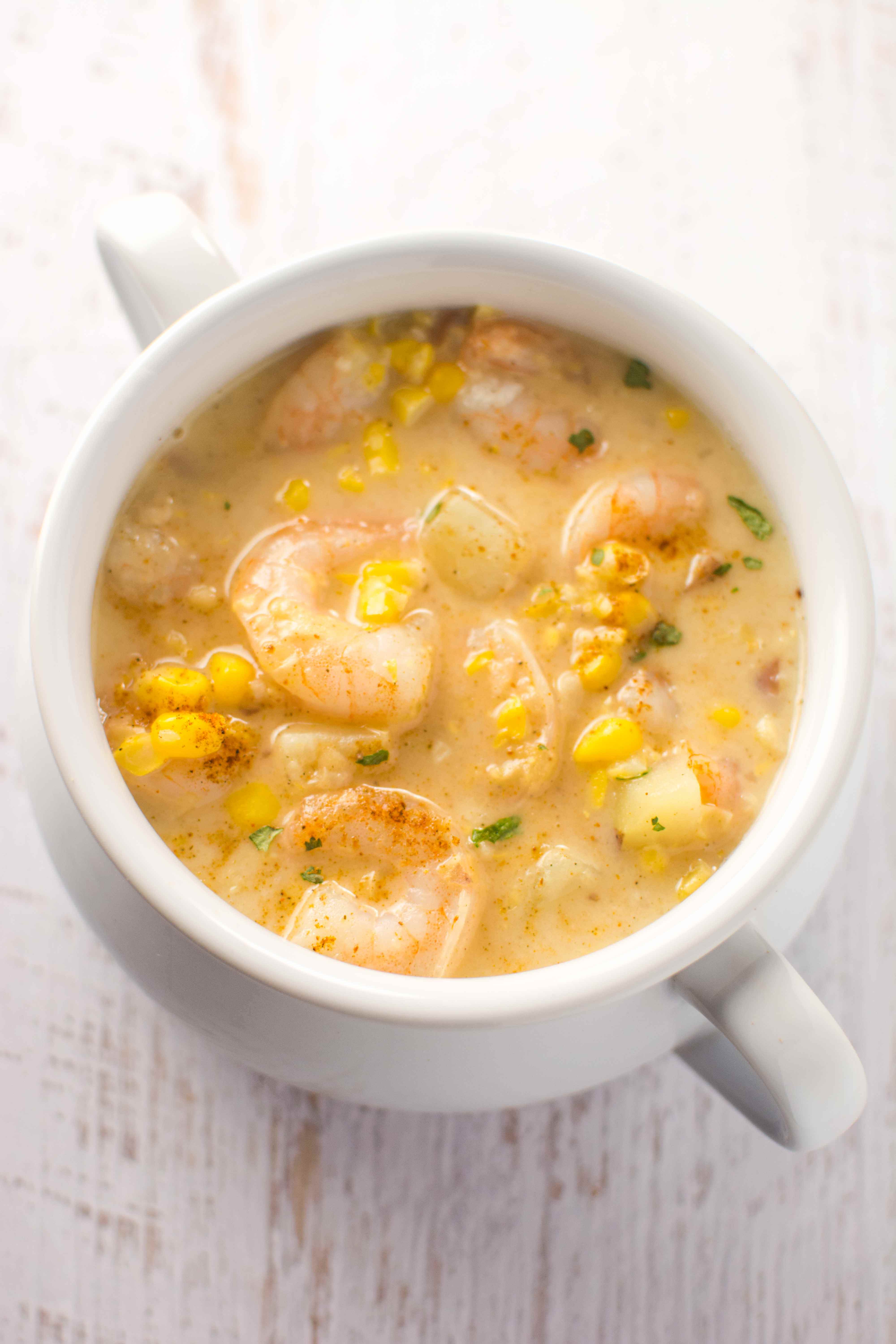 white bowl filled with cajun corn and shrimp chowder
