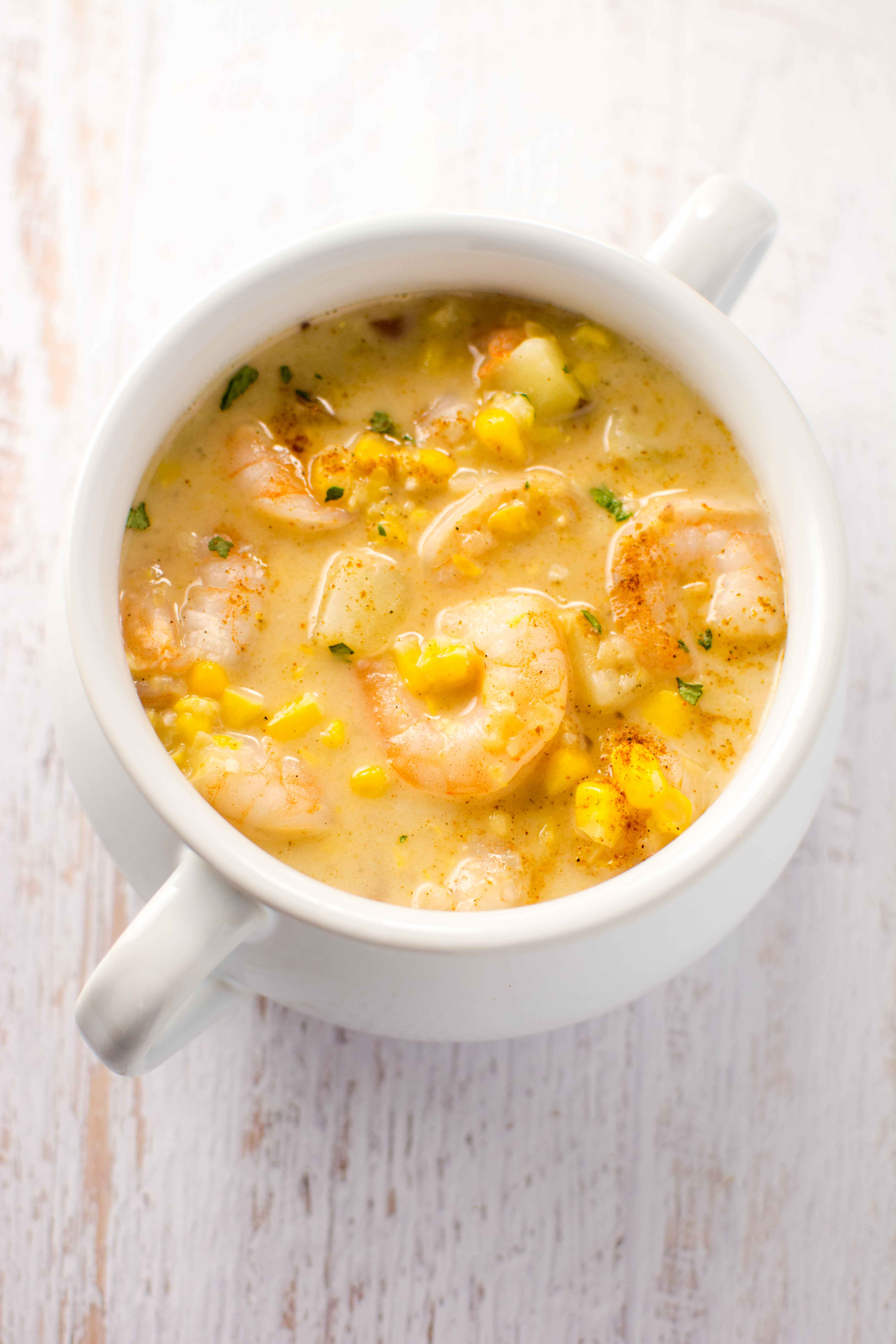 white bowl  filled with cajun corn and shrimp chowder