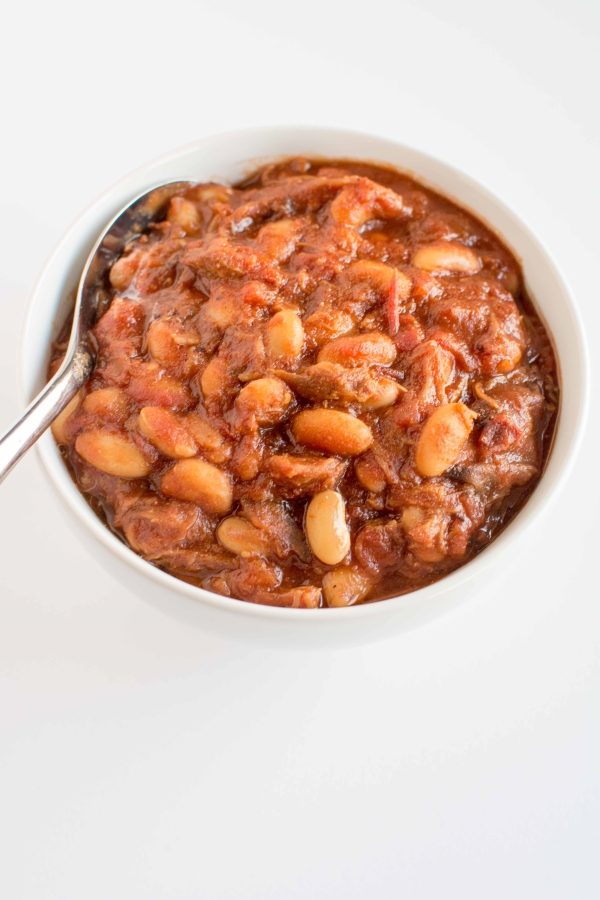baked beans in white bowl with spoon