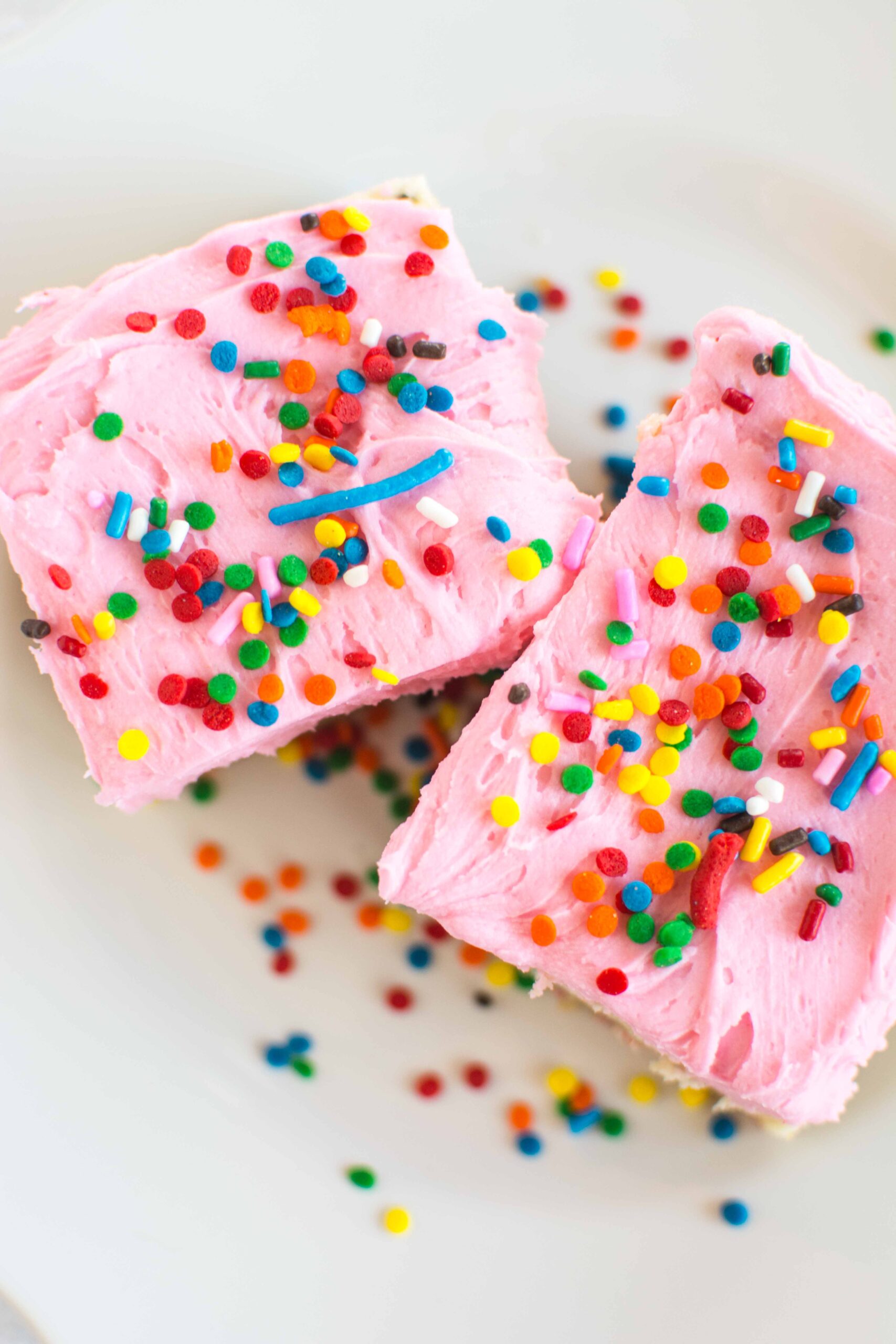 cookie bars on white plate with sprinkles
