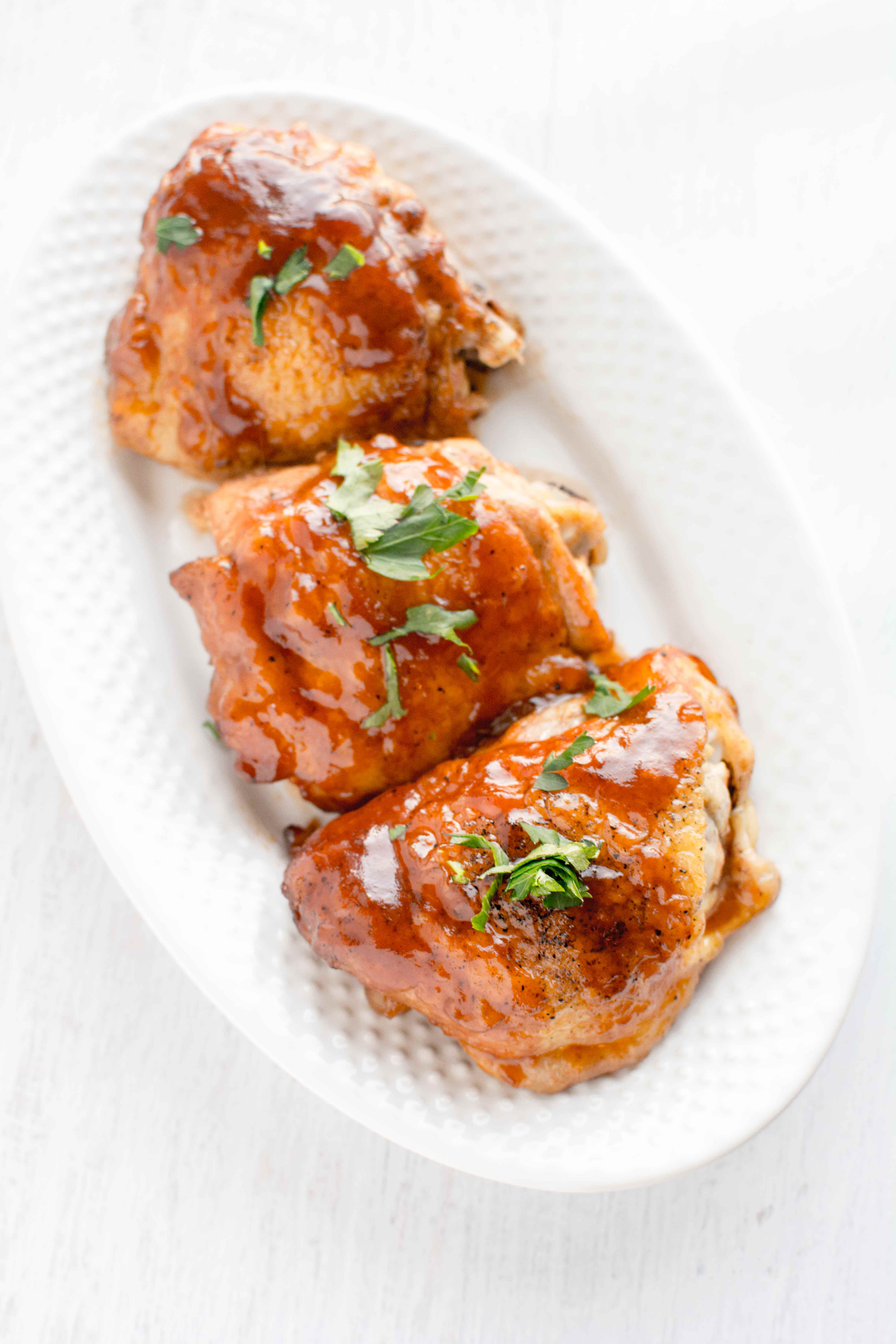 white plate with three pieces of honey chipotle bbq chicken