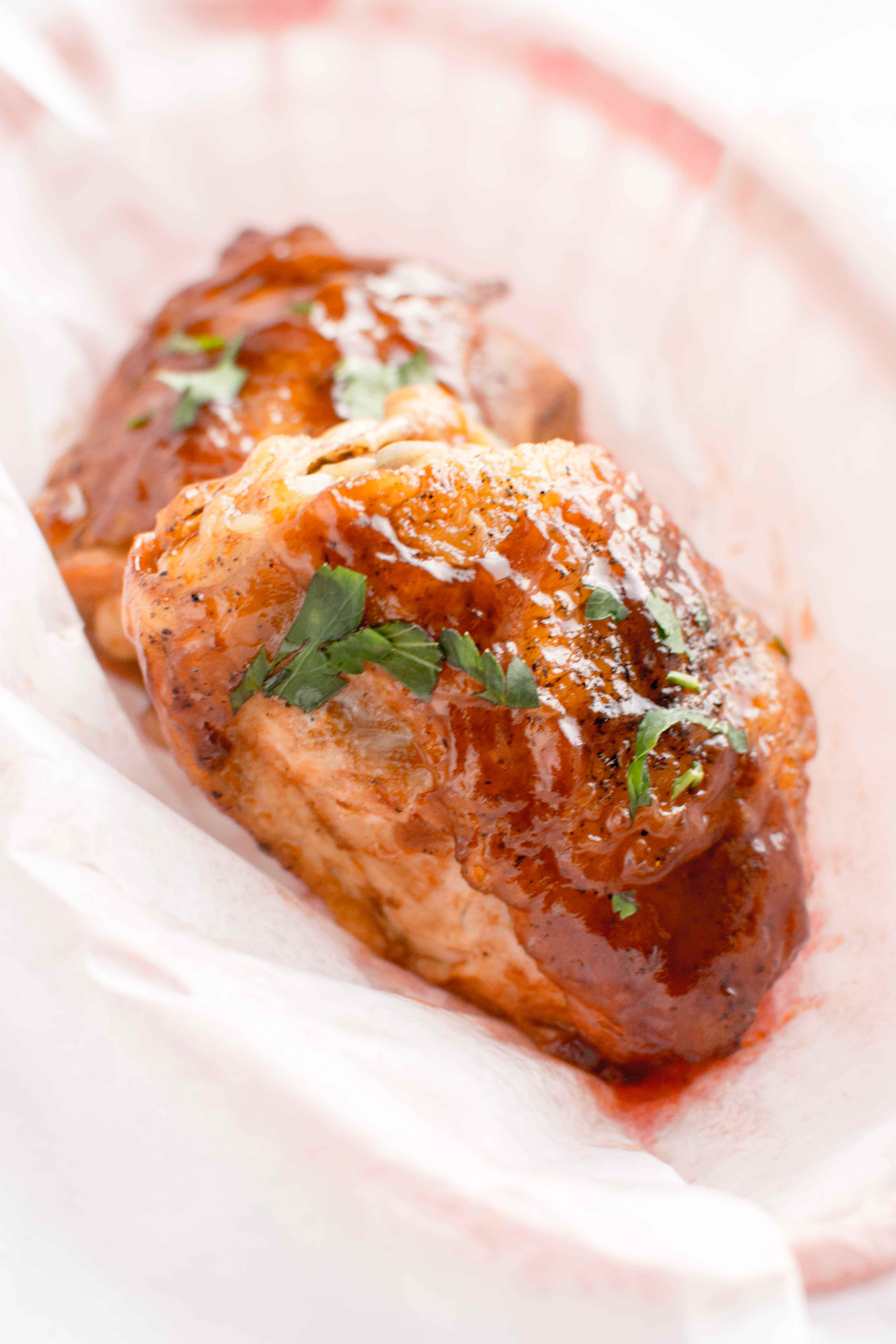 parchment lined basket with two pieces of honey chipotle bbq chicken