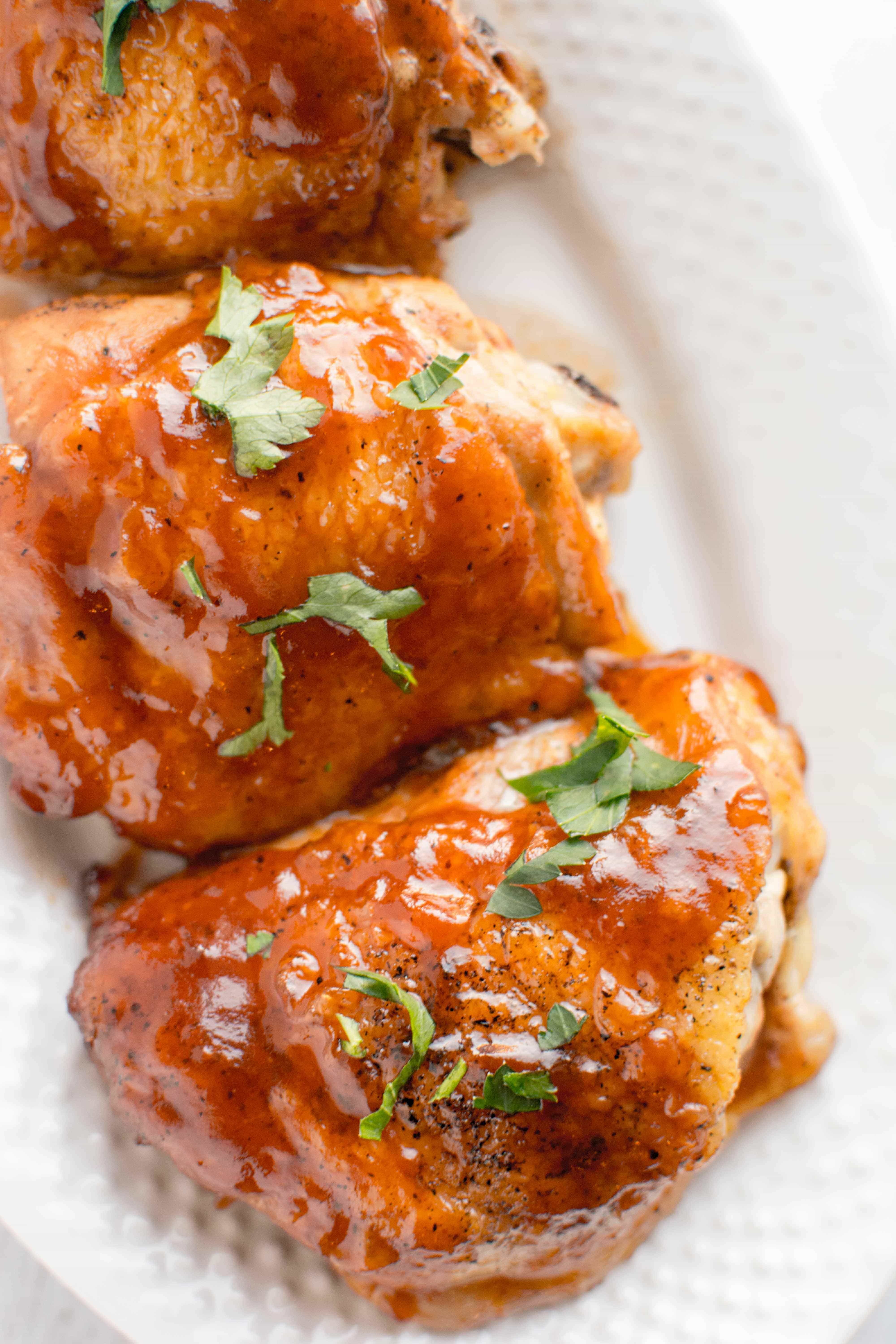 white plate with three pieces of honey chipotle bbq chicken