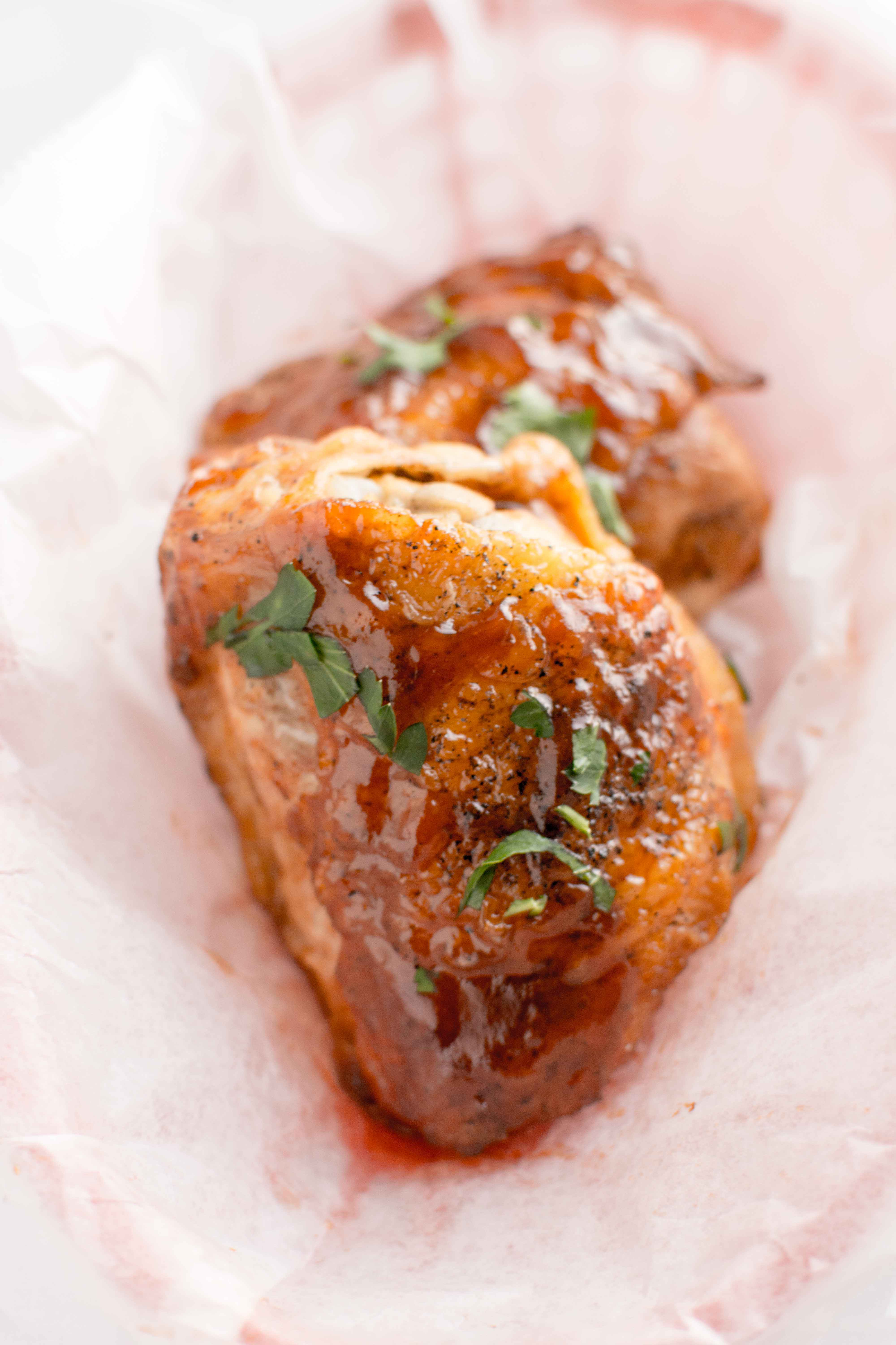 parchment line basket with two pieces of honey chipotle bbq chicken