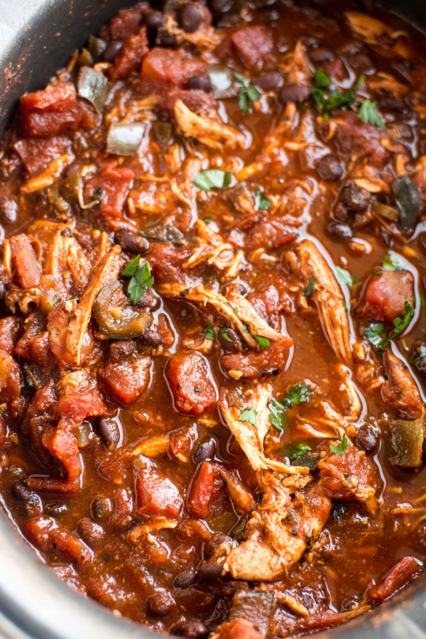 roasted tomato and ancho chicken chili in white slow cooker