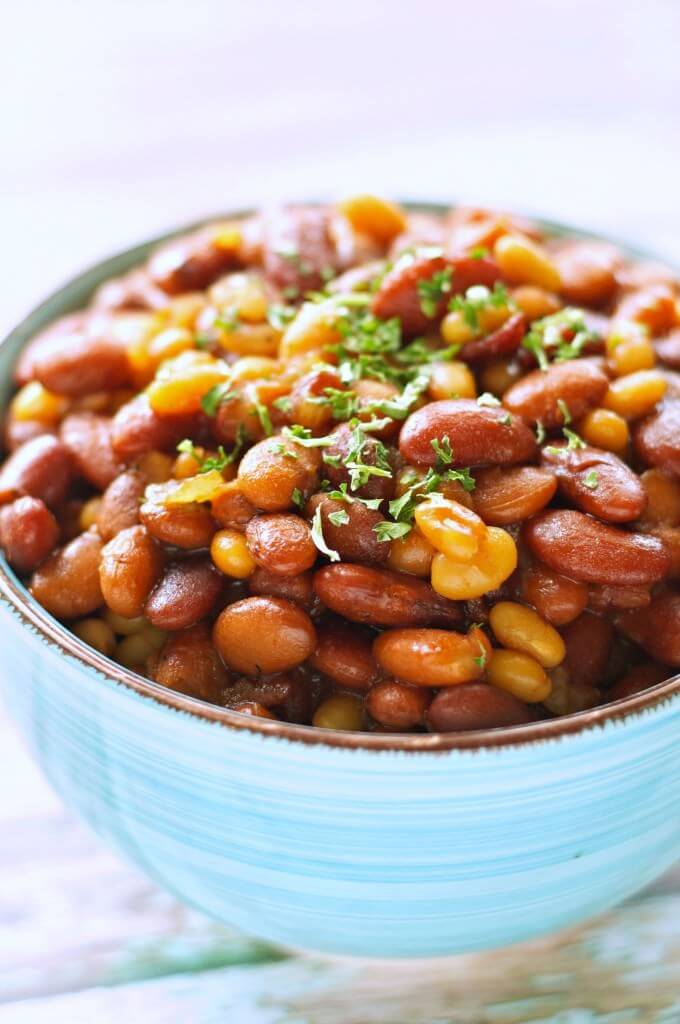 light blue bowl filled with honey bbq baked beans