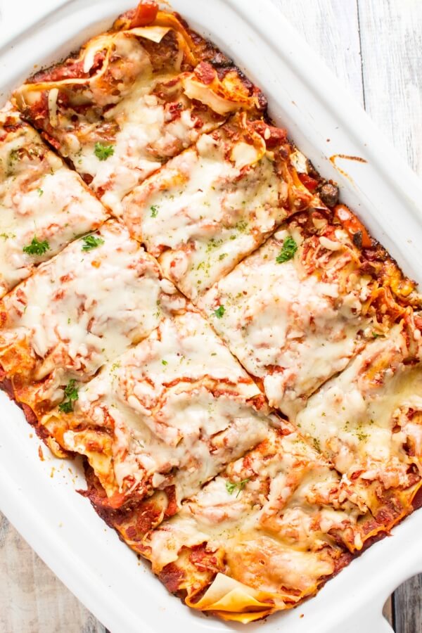 Slow Cooker Veggie Lasagna sliced in eight servings in a slow cooker 