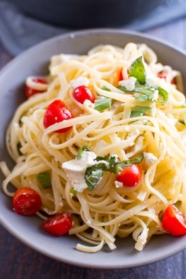 tomato basil and goat cheese pasta in gray bowl
