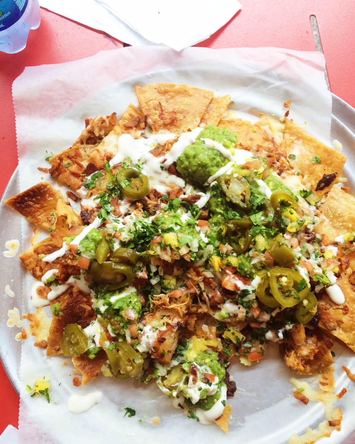 parchment lined plate with takeout nachos 