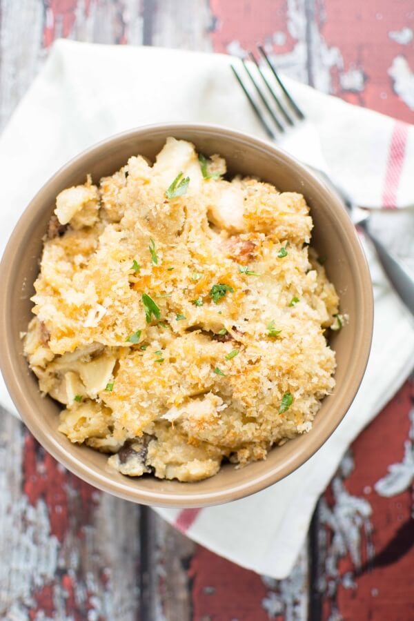five cheese chicken bacon pasta in brown bowl with fork on side